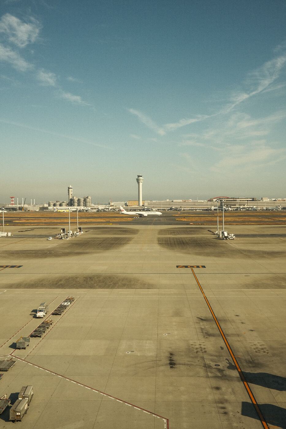 Airport runway and control towers under a clear sky