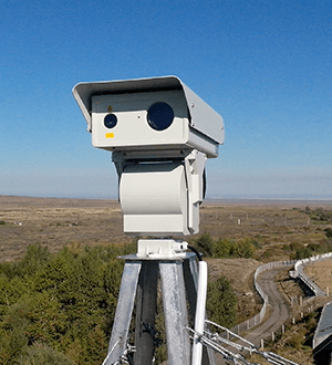 Border surveillance mast with thermal and radar heads on a desert track